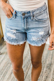 Short en jean bleu foncé à ourlet effiloché
